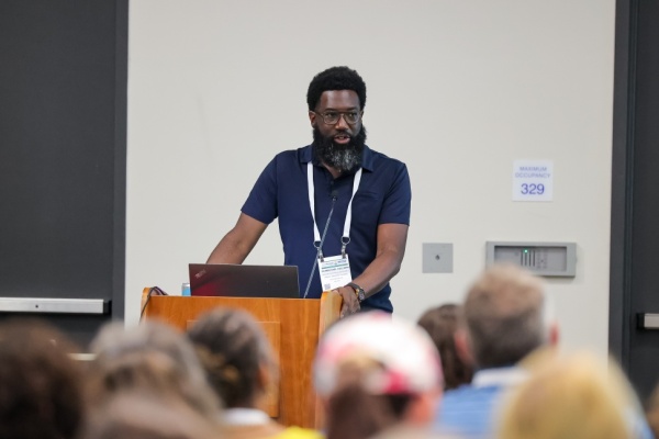 shamichael hallman speaks at a podium at ALA Annual 2024